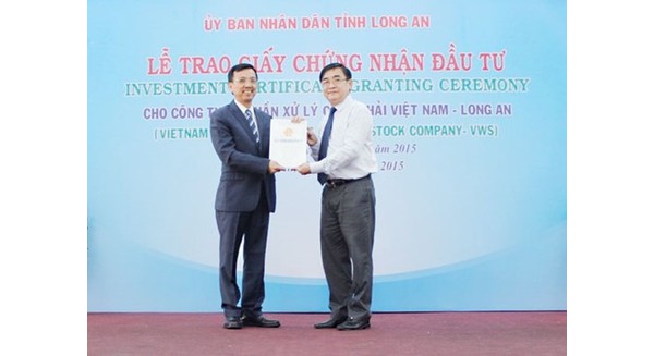 "Vua rác" Việt kiều Davis Dương (bên trái) nhận giấy chứng nhận đầu tư của Chủ tịch UBND tỉnh Long An
